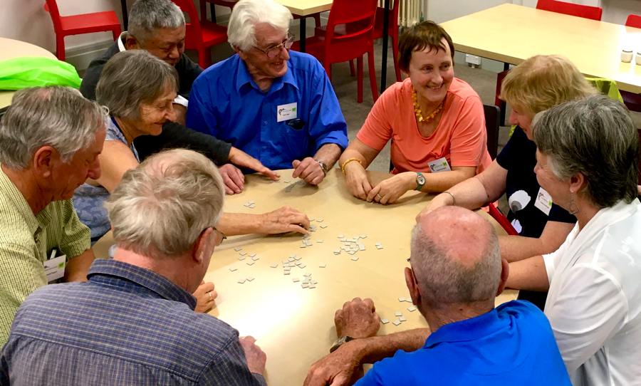 People playing a game around a circular table